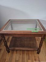 Full view of wood end table showing glass top and cane shelf