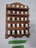 Full view of wood shelf holding all thimbles