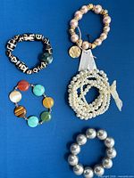 Group shot of all five bracelets displayed on blue background