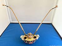 Front view showing inkwell with two metal/cane pen rests inserted