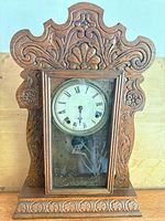 Front view of carved oak gingerbread mantel clock