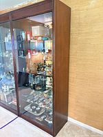 Full side view of mahogany glass display cabinet