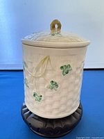 Front view of Belleek shamrock basketweave jar with lid