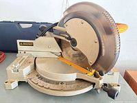 Overall view of DeWalt compound miter saw, blade guard and base visible