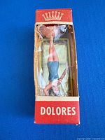Front view of boxed Dolores figurine showing figure and crown logo