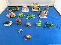 All sixteen frog items laid out on blue surface