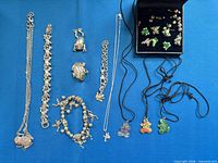 Group shot of all jewellery pieces laid out on blue background