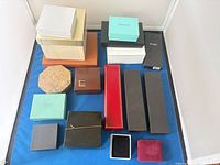 Overview of assorted presentation boxes laid out on blue surface