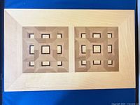 Top view showing geometric inlaid lid design and maple tone finish