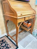 Full view of oak roll-top writing desk closed