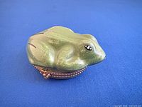 Side view of frog-shaped porcelain box closed