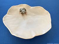 Top view of porcelain lily pad dish showing frog figurine and overall shape