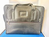 Front view of black leather Case-Tek briefcase with handles and front zip pocket