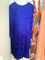 Blue tonal animal print dress with ruffle skirt hanging