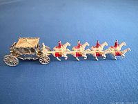 Side view of entire coach with horses and riders