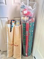 All packaging components: wrapping paper sleeves and clear tube with rolls, ribbon and bows