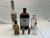 Group shot of all six antique bottles standing
