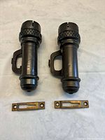 Two metal wall-mount oil lamps with mounts