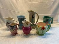 All seven English porcelain pitchers grouped