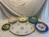 Group shot of six porcelain serving pieces
