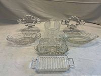 All seven clear glass pieces arranged together for full lot overview