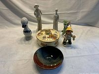 Group shot of all seven porcelain and pottery items