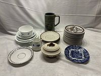 Entire assortment showing stacks of saucers, plates, Wade stein and sugar bowl, Adderleys creamer and bowl