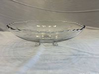 Side view showing three-toed base and scalloped rim