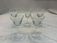 Group shot of five Cornflower etched liqueur glasses