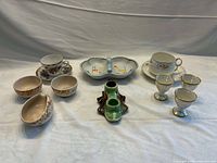 All thirteen porcelain pieces laid out