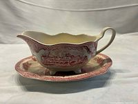 side profile of Johnson Bros Old Britain Castles gravy boat on underplate