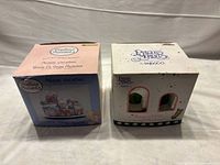 Both original Precious Moments musical waterball boxes front view
