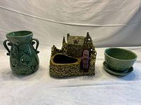 Group view of three Shawnee pottery pieces: mill planter, vase, pot with saucer