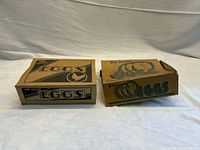 Both vintage cardboard egg cartons side by side, full view