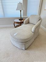 Chaise lounge, side table, and brass lamp in situ