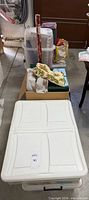 Stacked storage bins with Christmas wrapping paper and boxed items