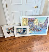 Group shot of three serigraph prints: one large framed piece, two matted prints