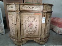 Front view of curved French Provincial console cabinet closed
