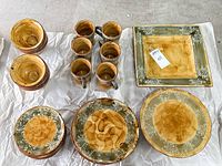 Group shot showing bowls, mugs, stacked plates, square serving pieces