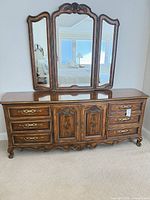 Front view of dresser with attached tri-fold mirror