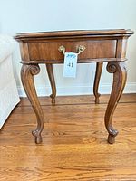 Full view of Heritage end table showing medium brown finish, single drawer, cabriole legs