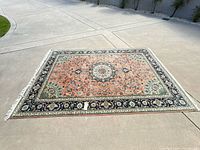 Full view of rug laid flat showing overall pattern, colors and fringe