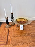 Candlesticks and bowl on floor