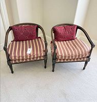 Pair of accent chairs with striped upholstery and burgundy pillows