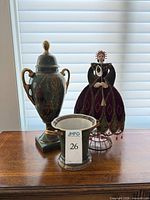 Overview of porcelain urn, ice bucket and fabric doll