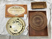 Top-down view of all items grouped: cedar plank, bowl, placemat, tray, basket