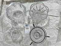 Four bowls arranged on sheet showing shapes and metal stand