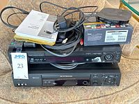 Stack showing Sony DVP-NS755V DVD player, Sony SLV-N99 VCR, Roku Ultra unit, remotes, cables and manuals
