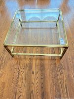 Full view of square brass and glass coffee table