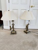 Both Stiffel brass and glass table lamps with shades on carpet